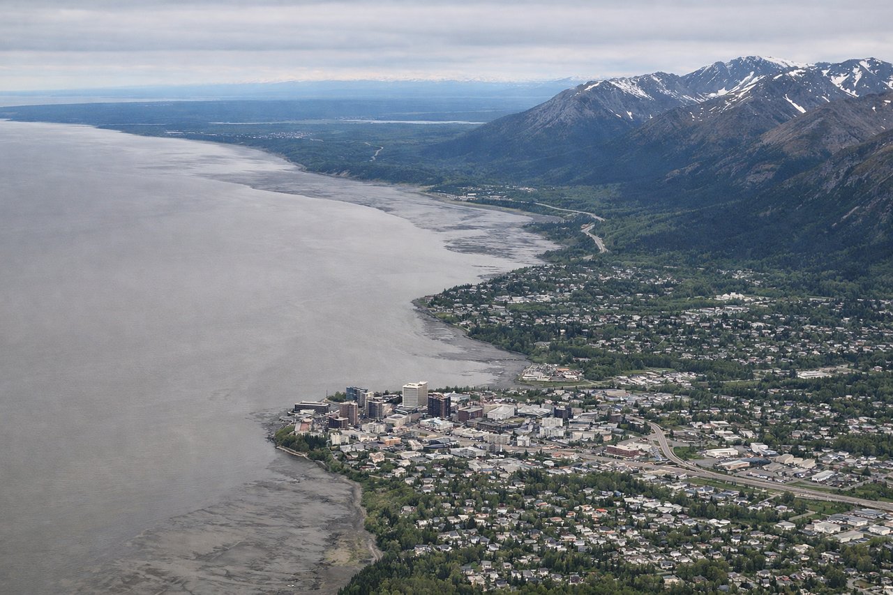 Left window seat view during landing at Anchorage (ANC) — Denali (weather permitting, ~130 miles north), Mount Susitna, Knik Arm, Mat-Su Valley lowlands