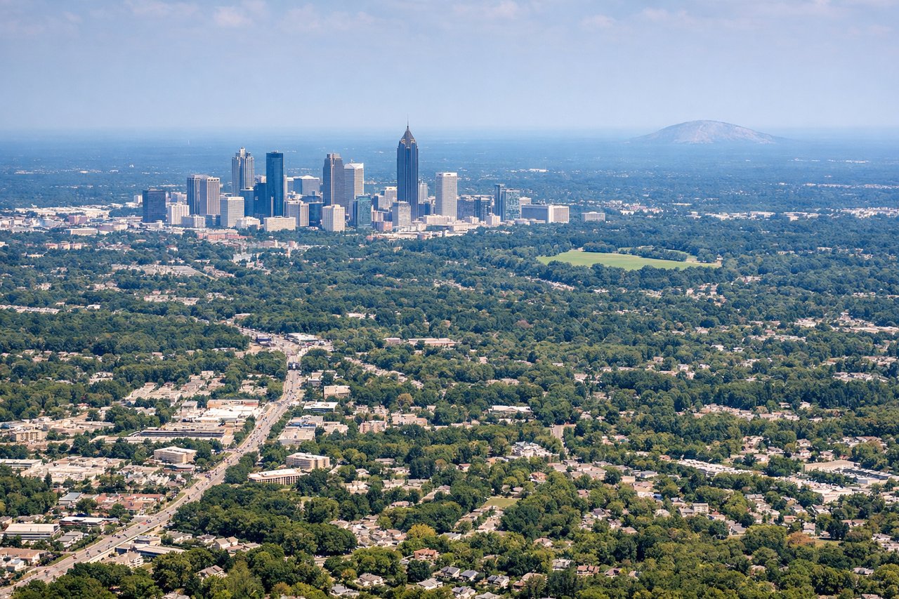 Aerial window seat view during takeoff from Atlanta (right side) — Stone Mountain, downtown Atlanta skyline, DeKalb County suburbs, Piedmont hills