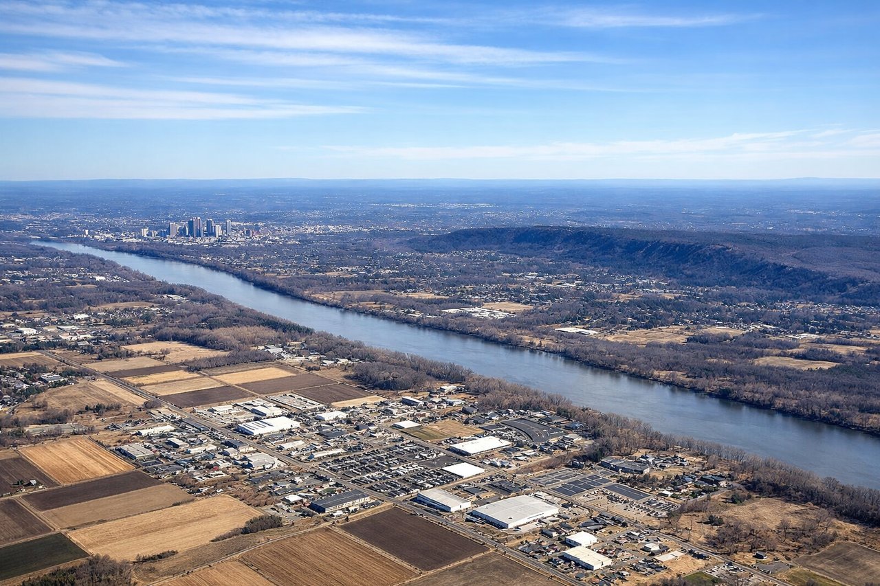 Left window seat view during takeoff from Windsor Locks (BDL) — Hartford downtown skyline, Connecticut River, Bradley International Airport perimeter fields