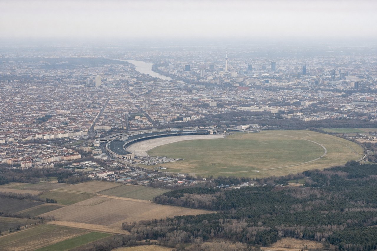 Left window seat view during takeoff from Berlin (BER) — Fernsehturm (Berlin TV Tower), Tempelhofer Feld park, Spree River through central Berlin, Reichstag/government district in the distance