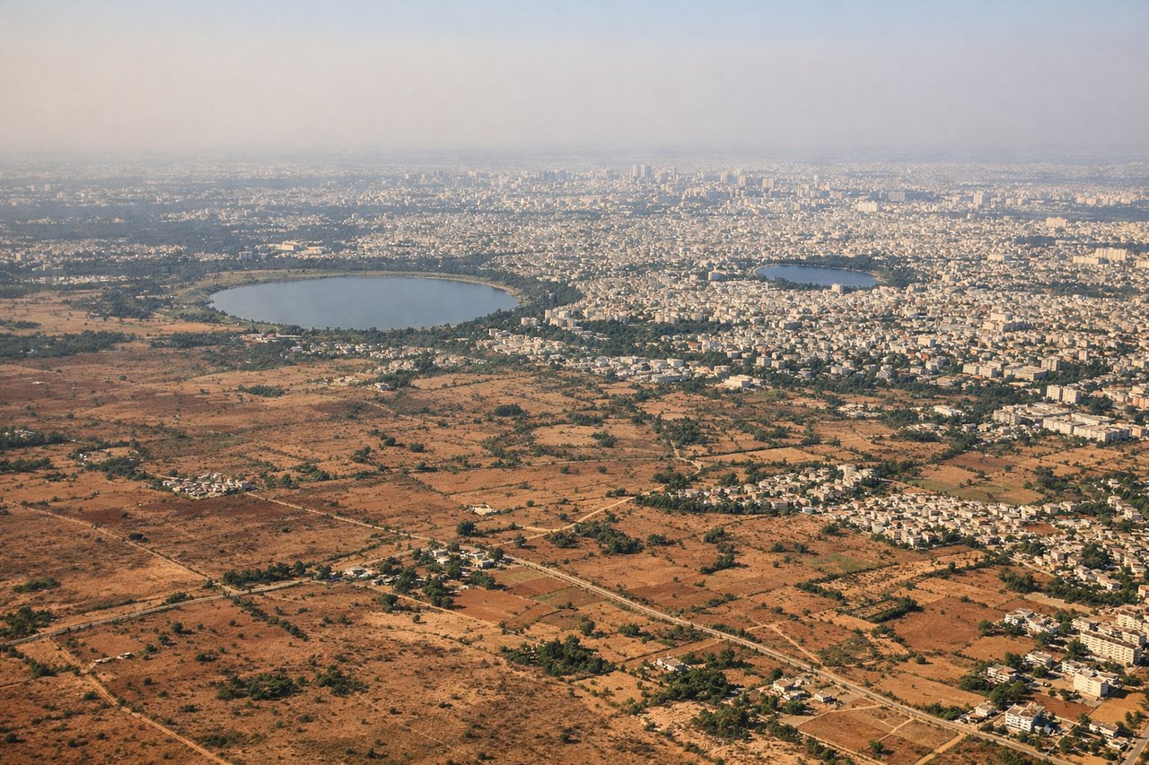 Aerial window seat view during landing at Bangalore (right side) — Nandi Hills, granite hillocks near Devanahalli, Bangalore's northern reservoirs, Deccan plateau farmland