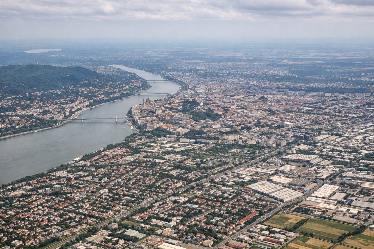 Aerial window seat view during takeoff from Budapest (left side) — Danube River through Budapest city center, Margaret Island, Buda Hills escarpment, Hungarian Plain extending south