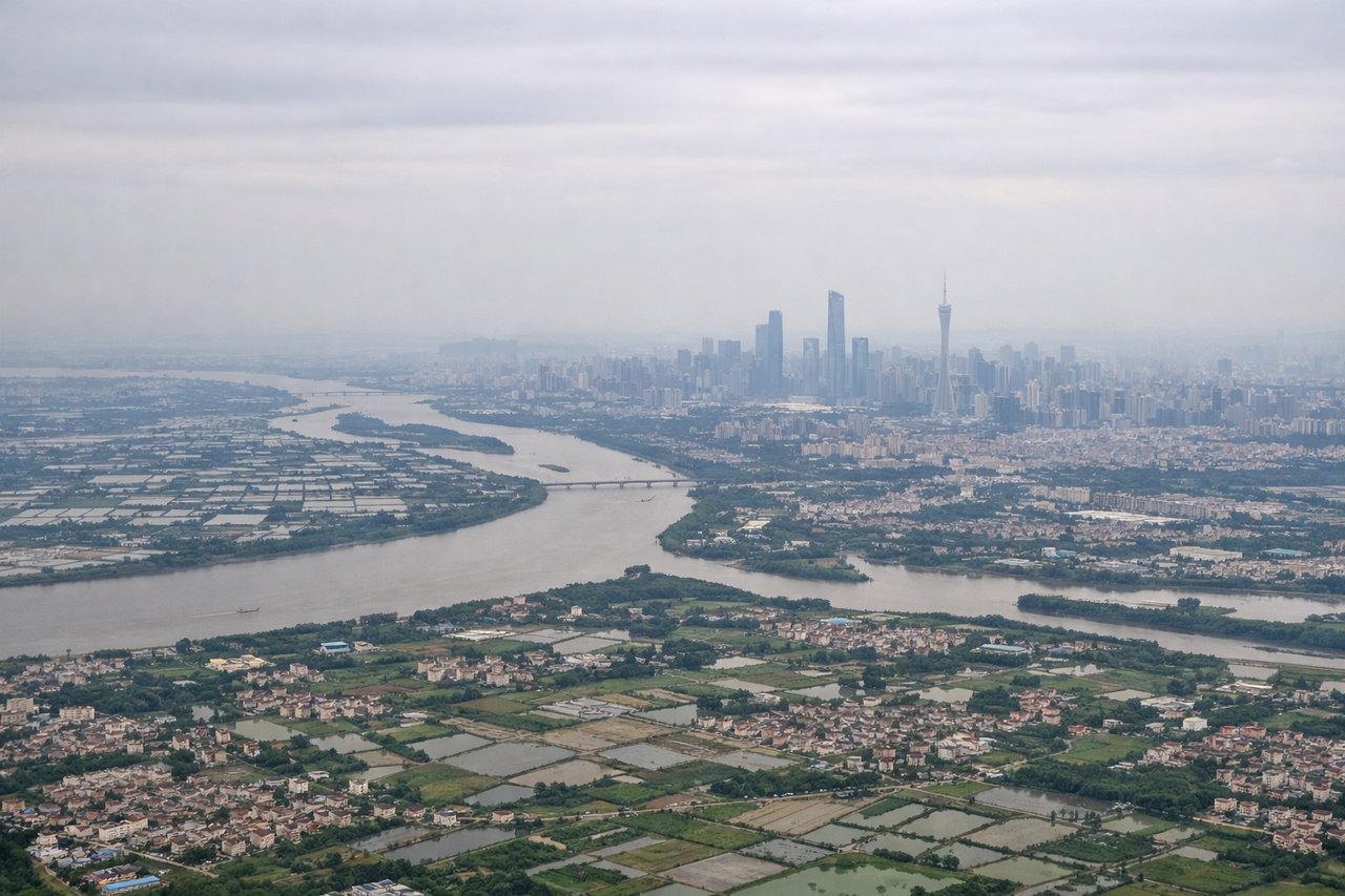 Aerial window seat view during landing at Guangzhou (right side) — Pearl River Delta waterways, Shenzhen skyline, Hong Kong's outlying islands, Guangzhou's high-rise districts near the Pearl River