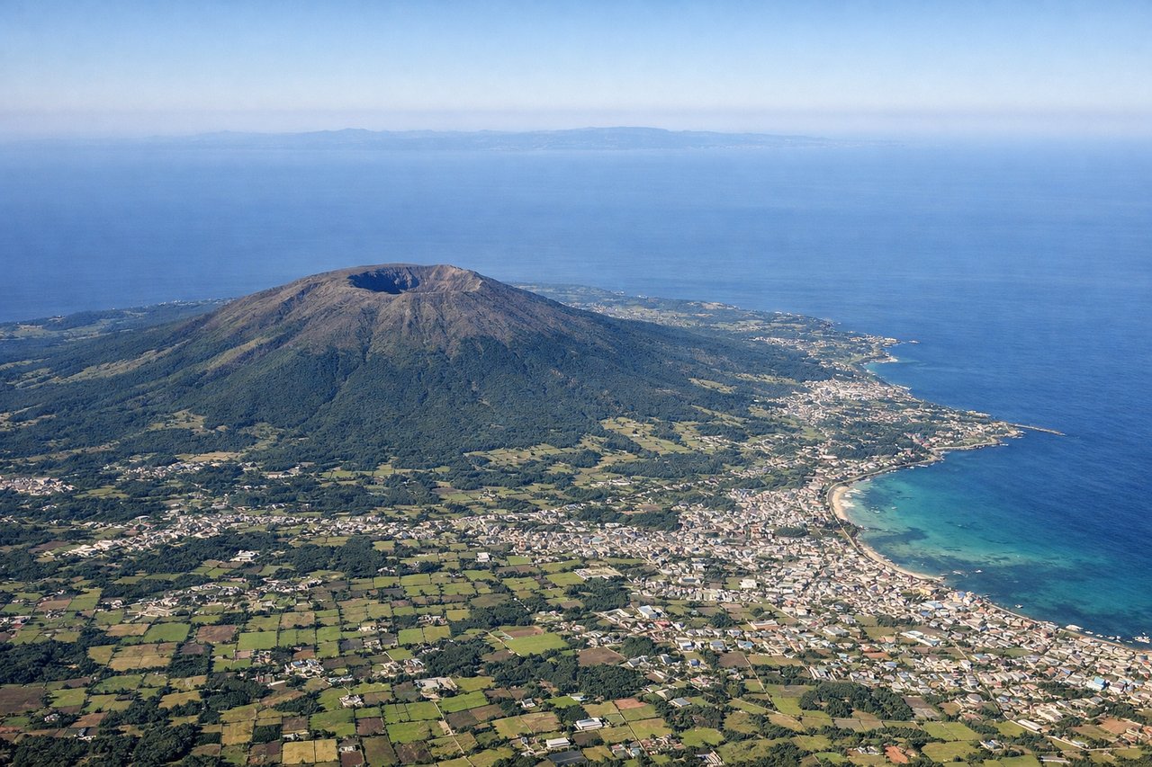 Aerial window seat view during takeoff from Cheju (left side) — Hallasan volcanic summit and crater, Jeju northern coastline, Korea Strait, distant southern tip of Korean peninsula