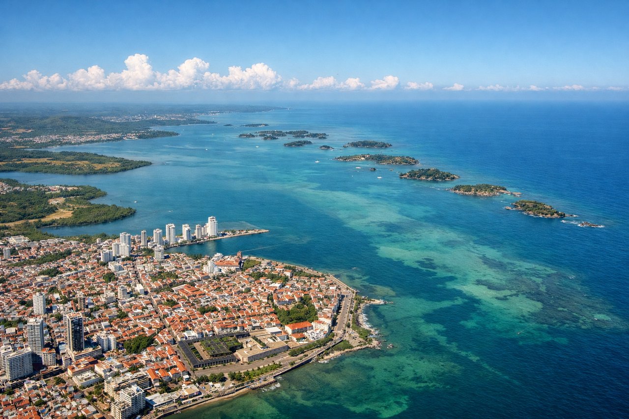 Right window seat view during takeoff from Cartagena (CTG) — Centro Histórico (walled Old City), Bocagrande skyscraper skyline, Cartagena Bay, Tierra Bomba Island