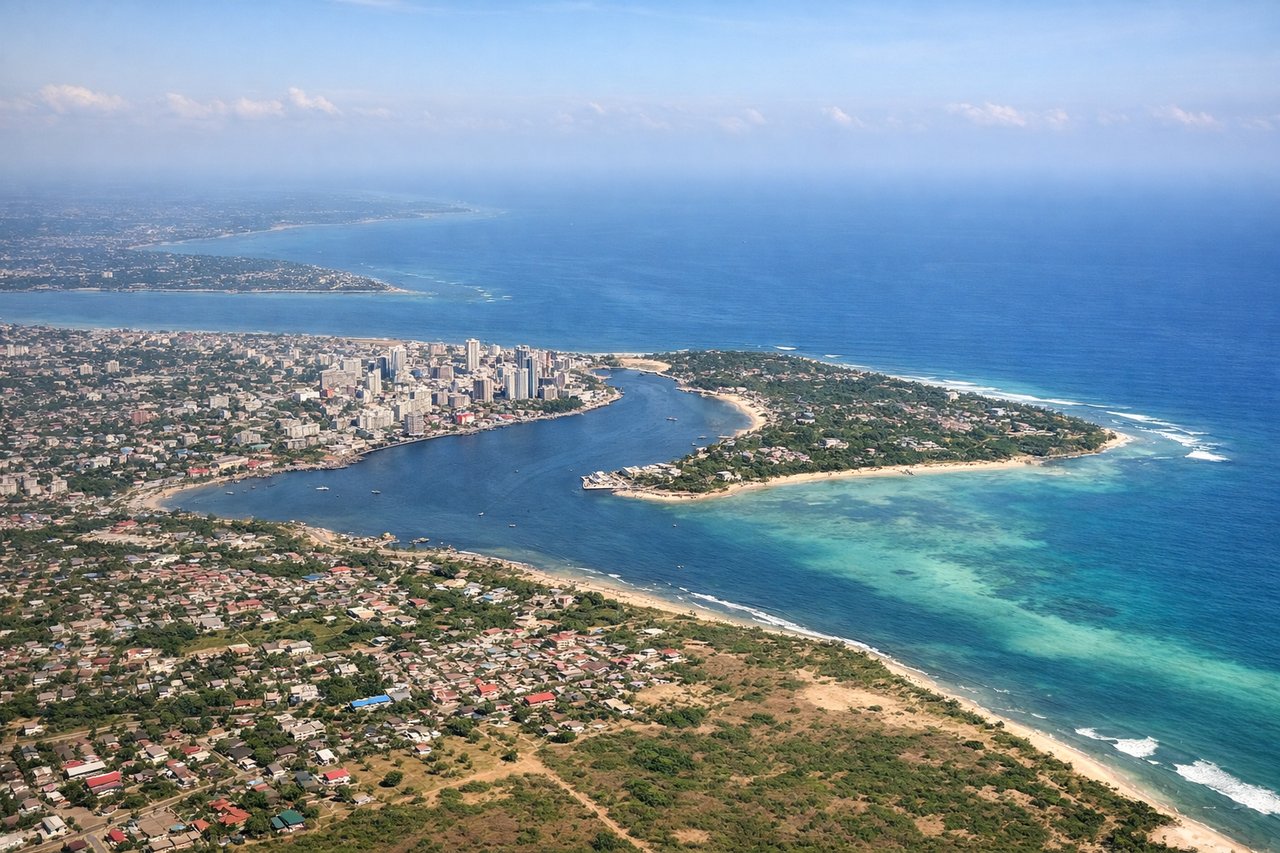 Aerial window seat view during landing at Dar Es Salaam (left side) — Indian Ocean coastline, Dar es Salaam harbor entrance, Msasani Peninsula, scattered offshore islands like Bongoyo Island