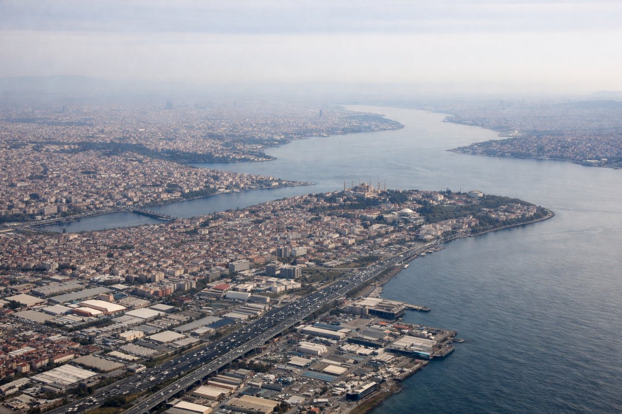 Aerial window seat view during takeoff from Istanbul (right side) — Bosphorus Strait, historic Istanbul peninsula (Hagia Sophia/Topkapi area), Sea of Marmara, Princes' Islands