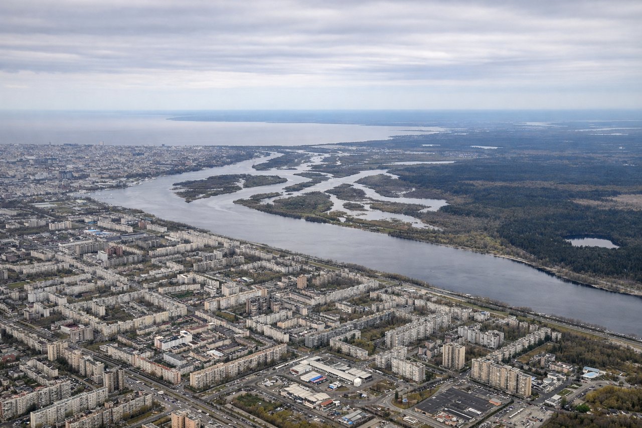 Aerial window seat view during takeoff from St. Petersburg (right side) — Gulf of Finland (north), Neva River delta and Saint Petersburg city sprawl (beneath/behind), Lake Ladoga (northeast on horizon), Karelian Isthmus forest (east)