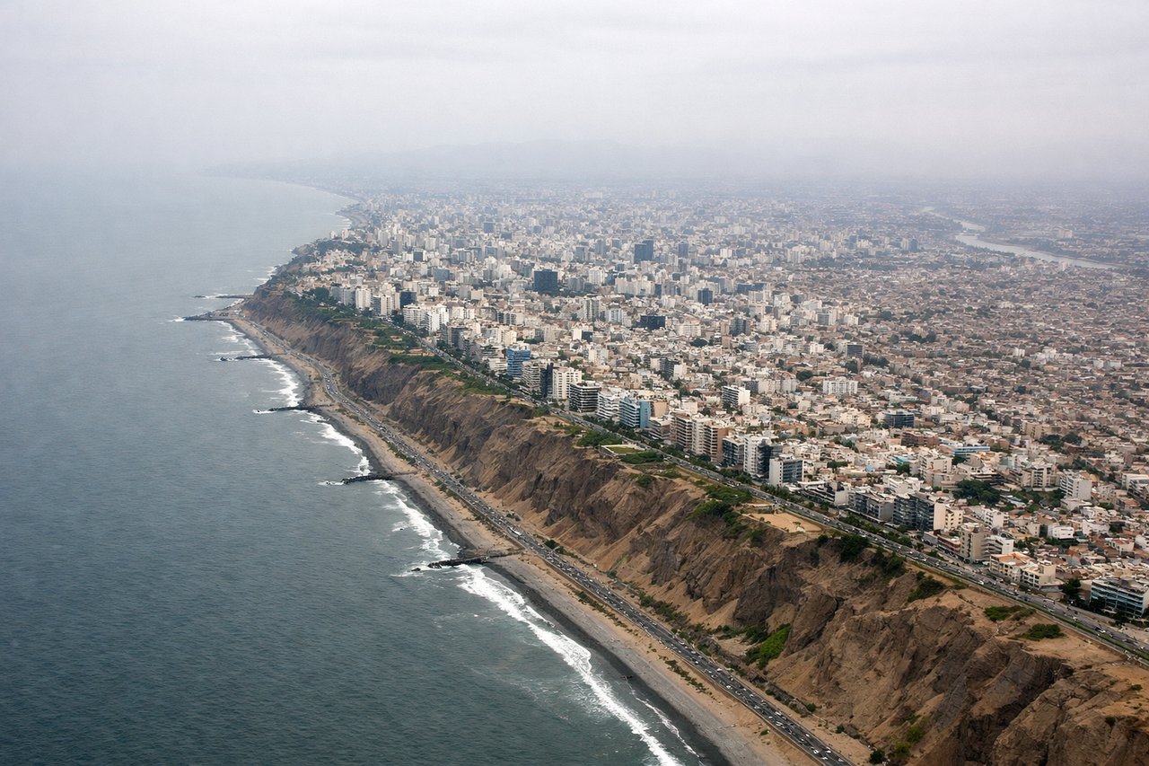 Aerial window seat view during landing at Lima (left side) — Andean foothills east of Lima, Rímac River valley, Lima's urban sprawl, San Cristóbal hill