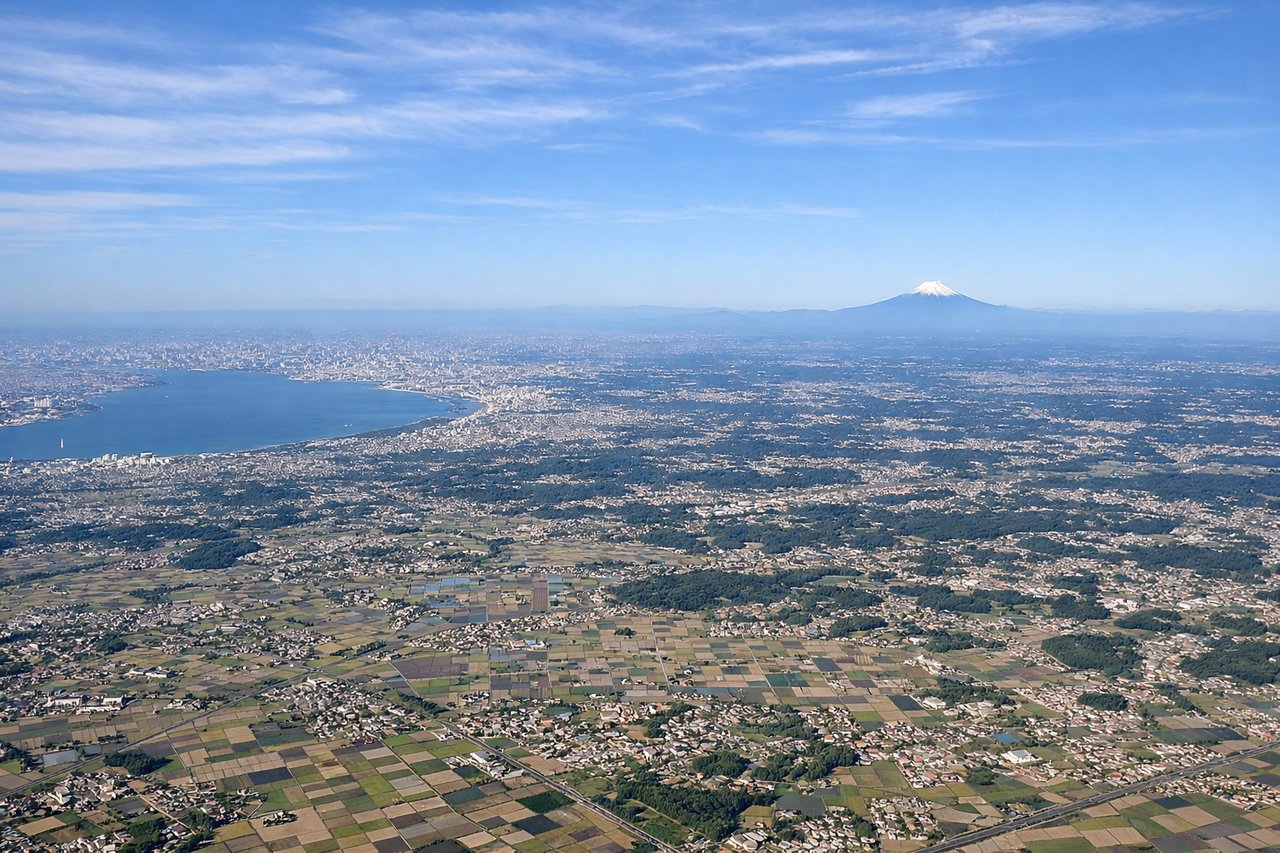 Left window seat view during takeoff from Tokyo (NRT) — Tokyo Bay, Greater Tokyo urban sprawl, Mount Fuji (distant, weather permitting), Chiba coastline