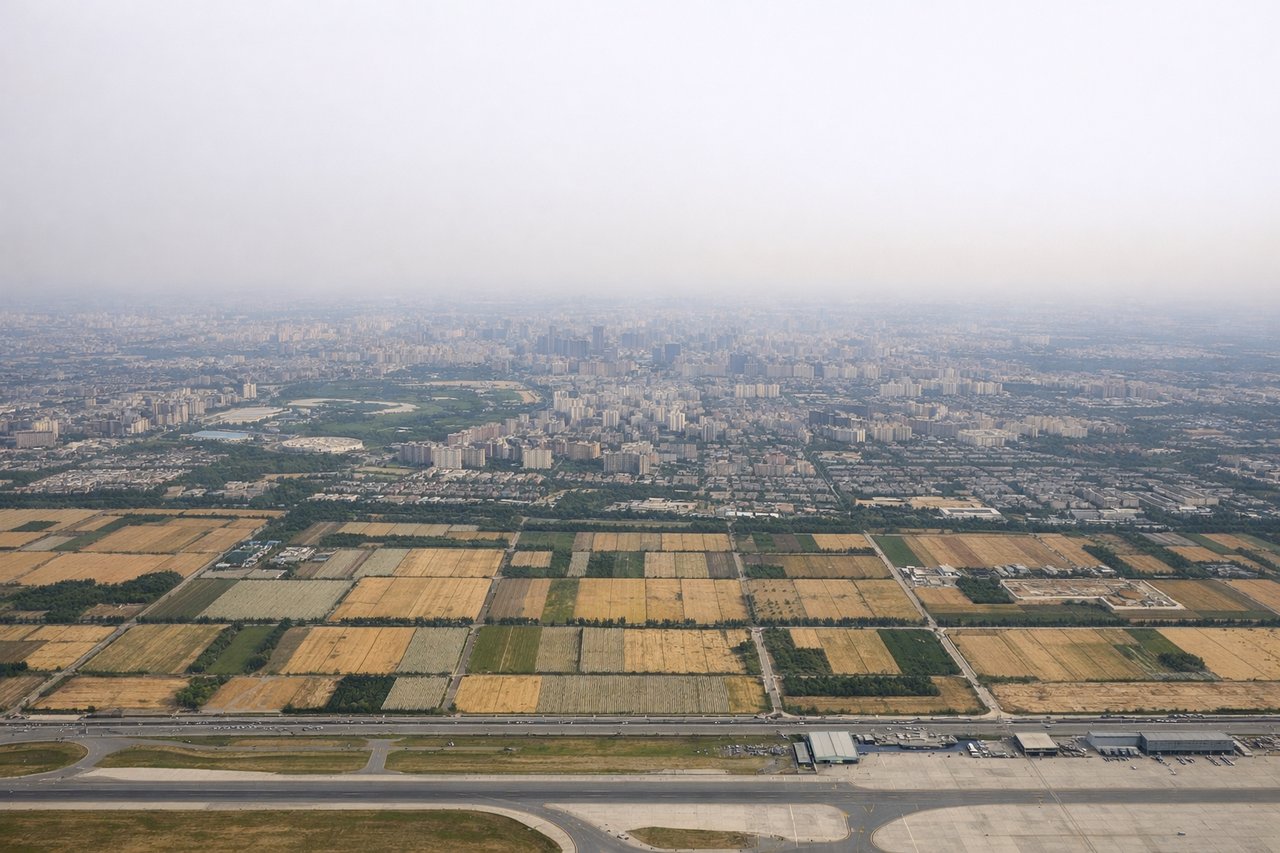 Aerial window seat view during landing at Beijing (right side) — Western Hills (Xishan) ridgeline, Fragrant Hills park area, edge of the North China Plain, distant Yan Mountains foothills