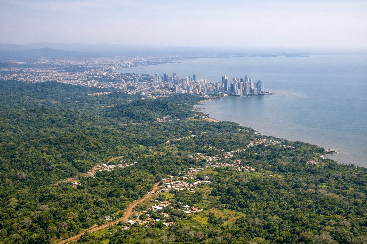 Right window seat view during landing at Panama City (PTY) — Panama City skyline (Punta Pacifica, financial district towers), Panama Canal entrance/Gatun Lake area to the southeast, Darién Gap forest mass to the south and southwest, Tocumen airfield taxiways and parallel runways below