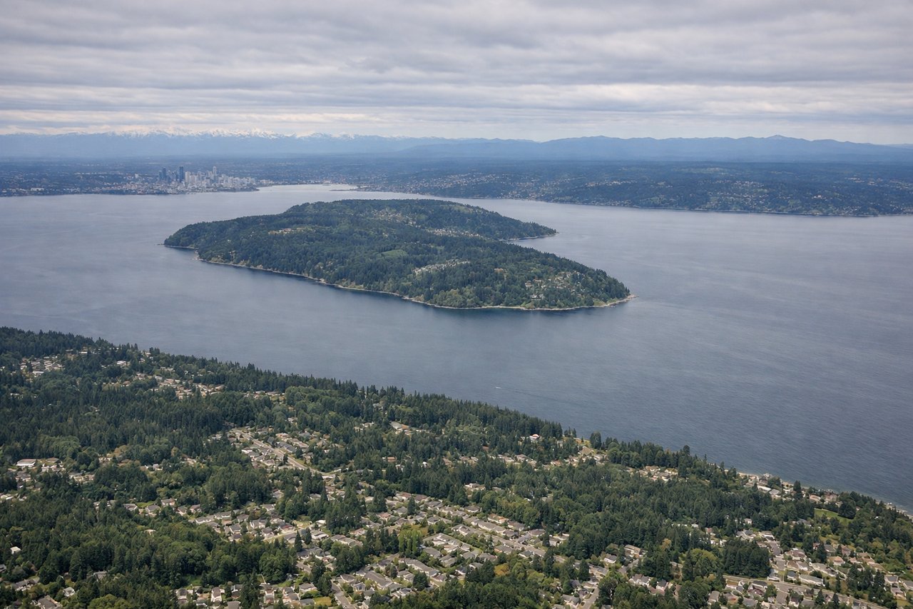 Right window seat view during landing at Seattle (SEA) — Puget Sound, Elliott Bay, downtown Seattle skyline, Olympic Mountains (distant horizon)