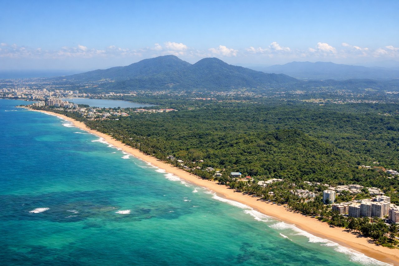 Aerial window seat view during landing at San Juan (right side) — El Yunque foothills, San Juan Bay and Old San Juan waterfront, Condado/Isla Verde beachfront skyline