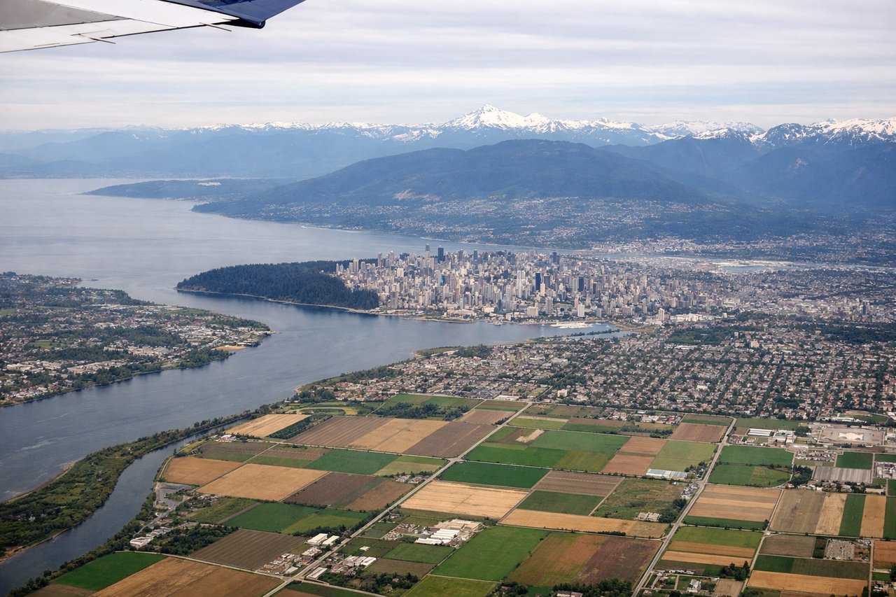 Left window seat view during takeoff from Vancouver (YVR) — Downtown Vancouver skyline, Burrard Inlet, North Shore Mountains (Grouse/Seymour/Cypress), Stanley Park peninsula