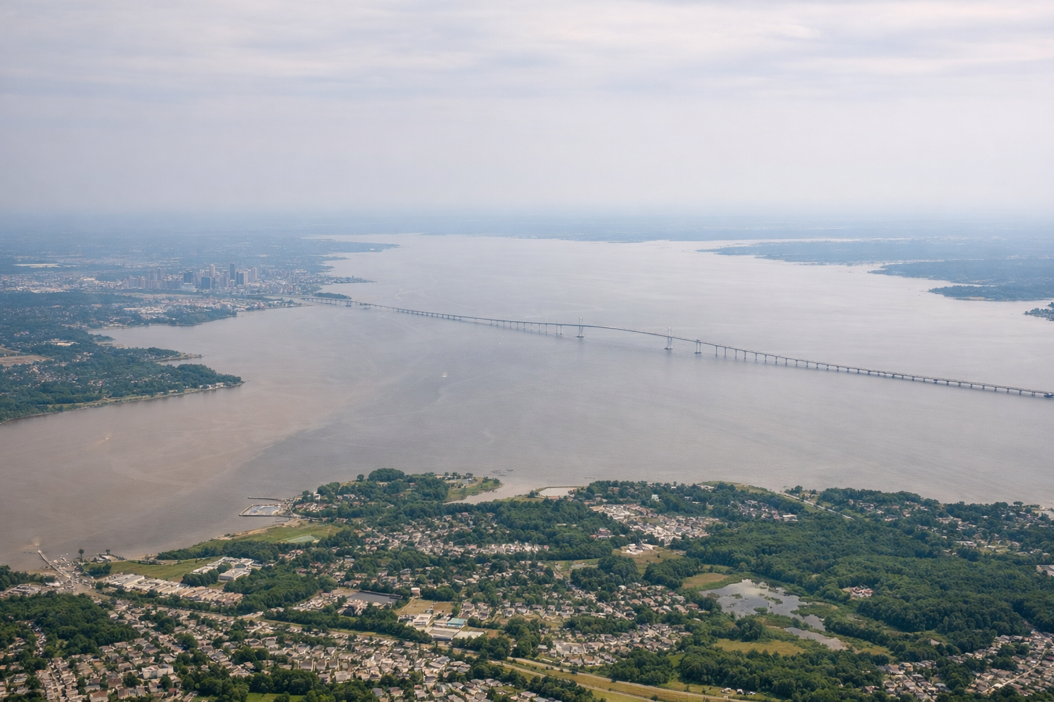 Aerial window seat view during takeoff from Baltimore (right side) — Downtown Baltimore skyline, Inner Harbor, Patapsco River, upper Chesapeake Bay