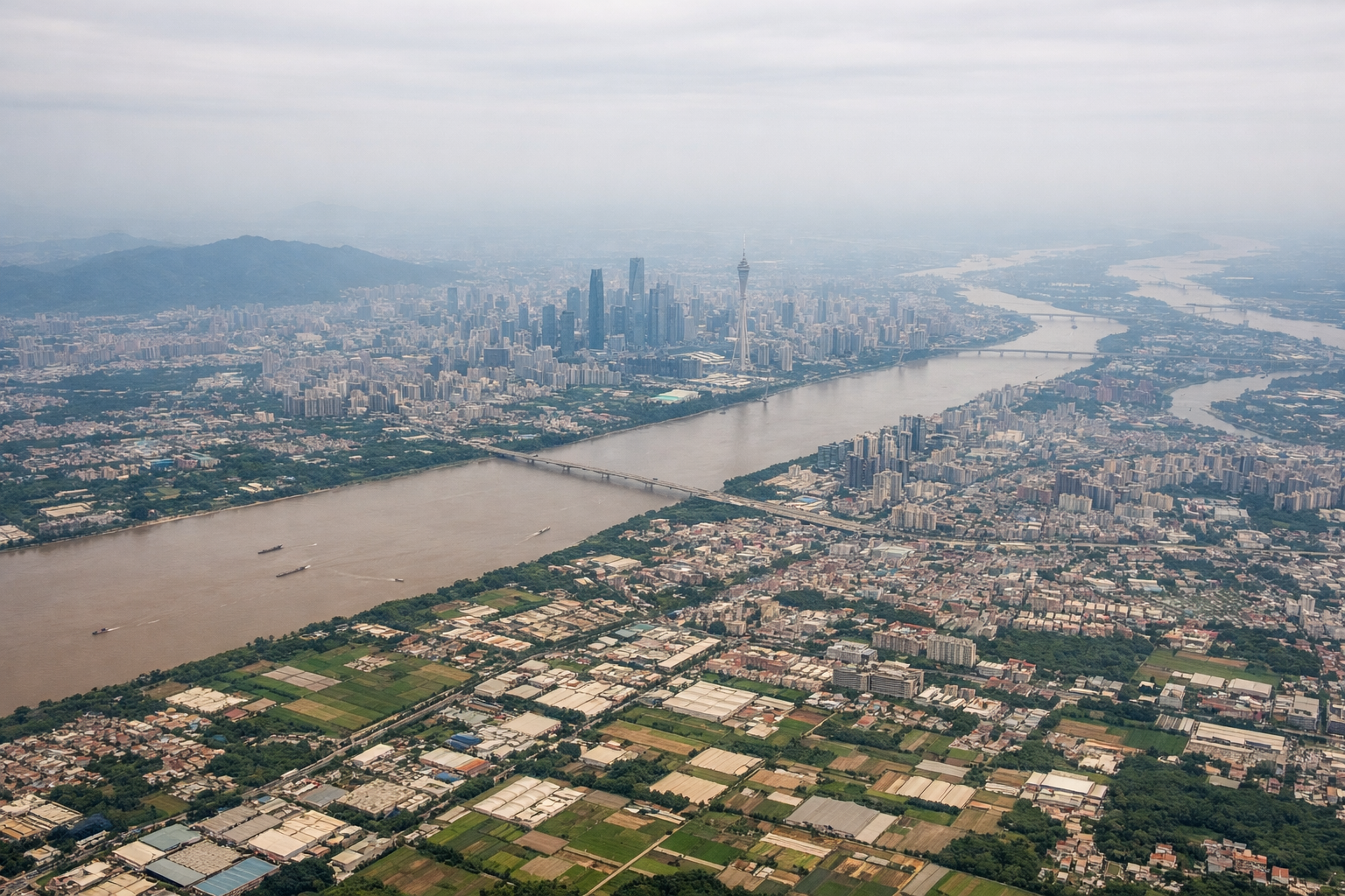 Aerial window seat view during takeoff from Guangzhou (left side) — Pearl River Delta, Guangzhou city skyline, Hong Kong/Shenzhen urban belt, Pearl River estuary