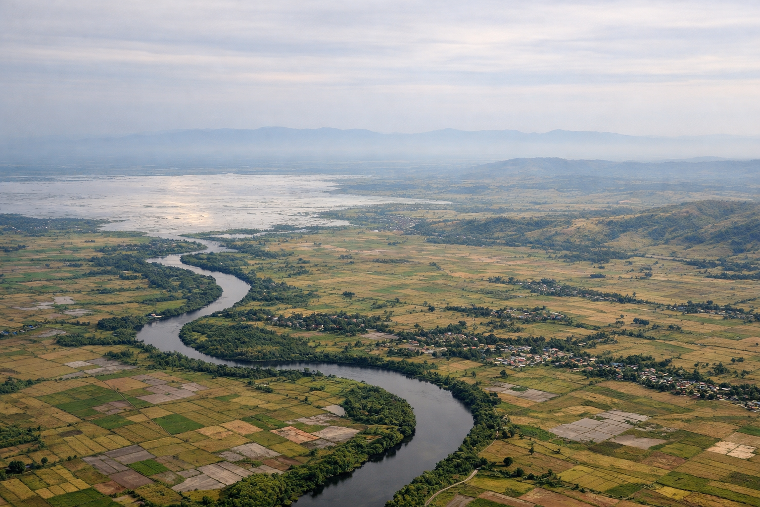 Aerial window seat view during takeoff from Cebu (left side) — Cebu City skyline, Mactan-Mandaue bridges, central Cebu mountain spine, Kanlaon Volcano (distant)