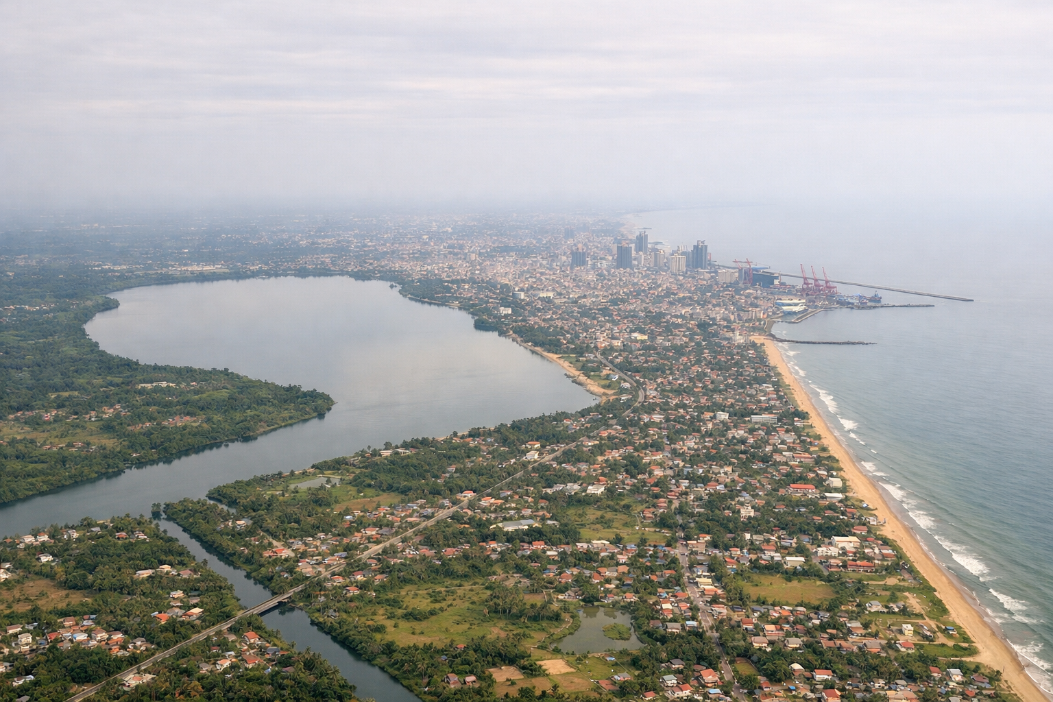 Aerial window seat view during takeoff from Colombo (left side) — Colombo harbor and skyline, Sri Lanka's west coast beaches, Kelani River mouth, Indian Ocean horizon