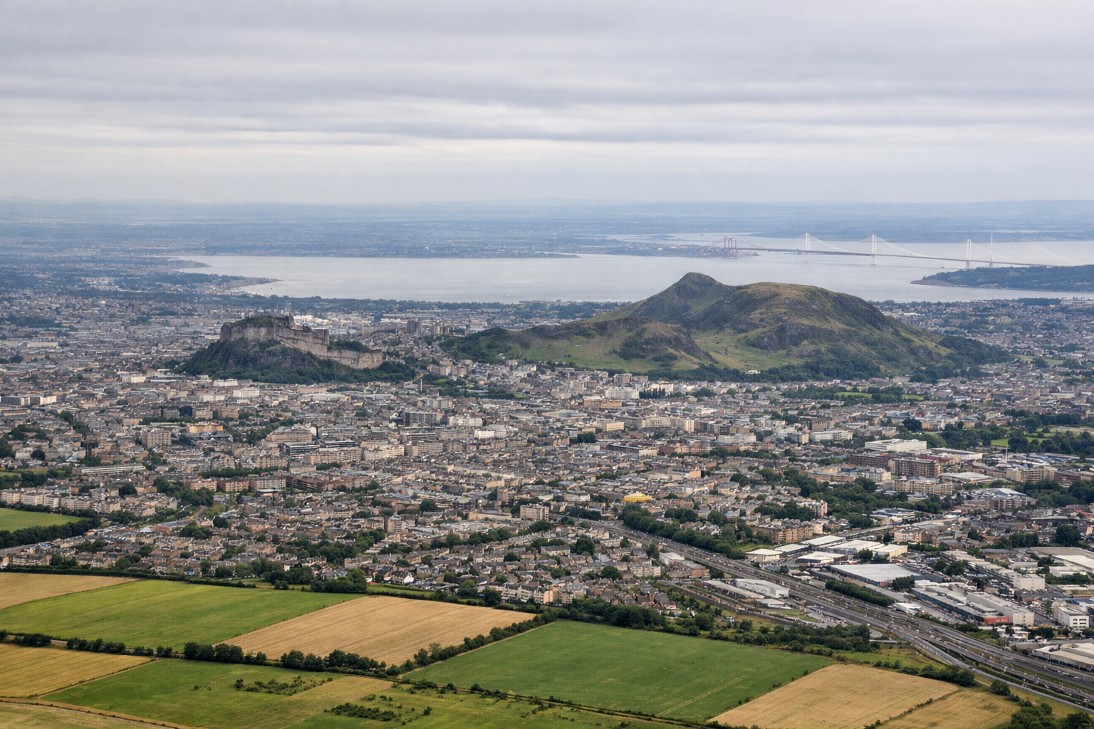 Aerial window seat view during takeoff from Edinburgh (right side) — Edinburgh Castle, Firth of Forth with the rail/road/Queensferry bridges, Arthur's Seat, Pentland Hills