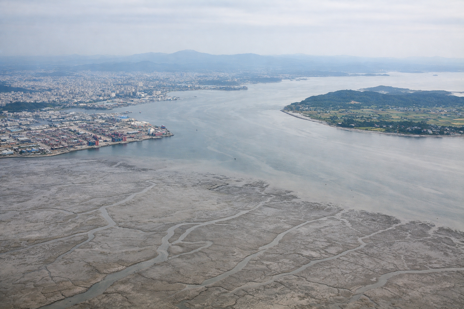 Aerial window seat view during takeoff from Seoul (left side) — Incheon tidal mudflats, Yellow Sea islands (Yeongjongdo, Ganghwado), Incheon coastline