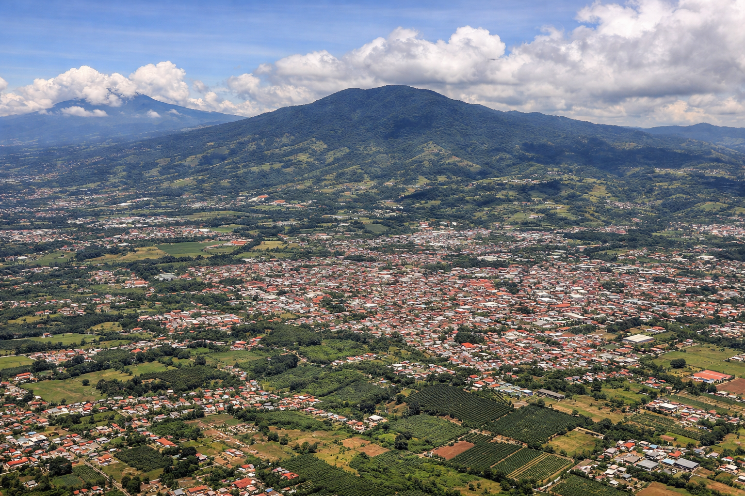 Aerial window seat view during landing at San Jose (right side) — Poás Volcano, Barva Volcano, Central Valley of Costa Rica, San Jose cityscape